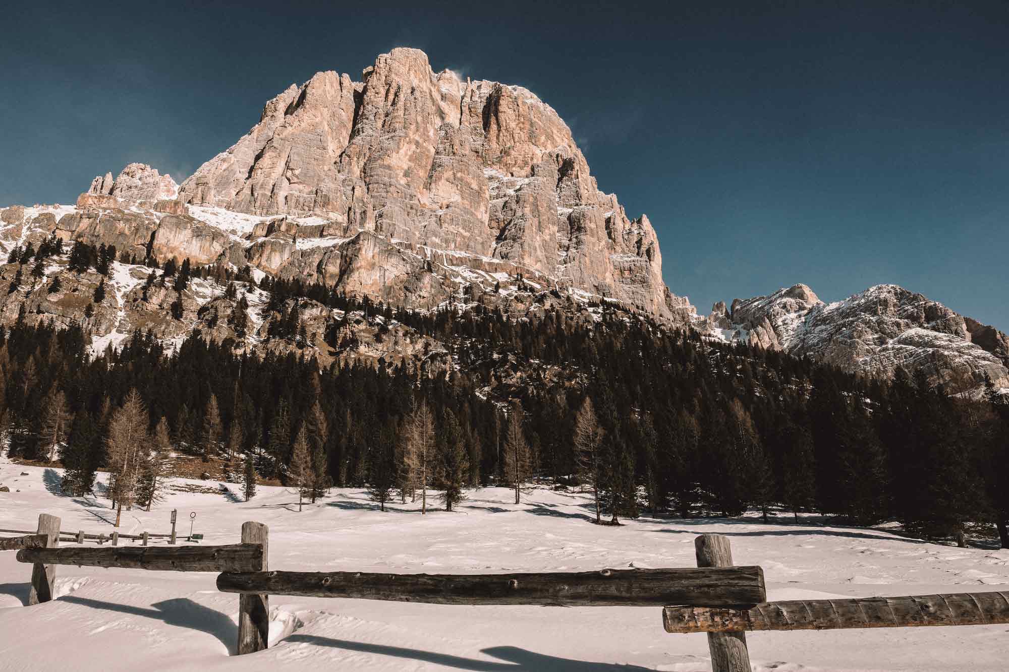 Snowy mountain landscape with wooden fence in Cortina d'Ampezzo