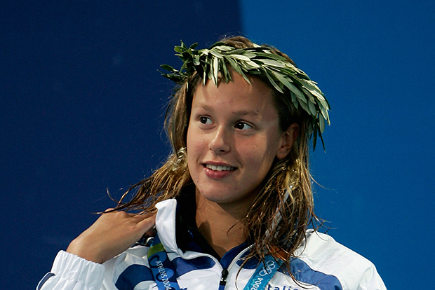 Silver medalist Frederica Pellegrini of Italy celebrates on the podium during the medal ceremony of the women's swimming 200 metre freestyle event on August 17, 2004 during the Athens 2004 Summer Olympic Games at the Main Pool of the Olympic Sports Complex Aquatic Centre in Athens, Greece. Camelia Potec of Romania won gold and Solenne Figues of France won bronze. 