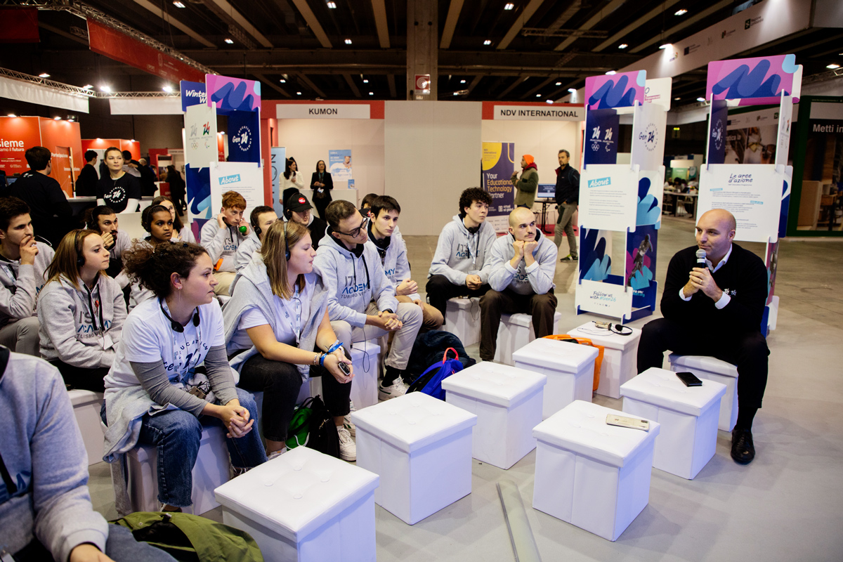 A group of seated and attentive young people attending a Gen26 job guidance presentation.