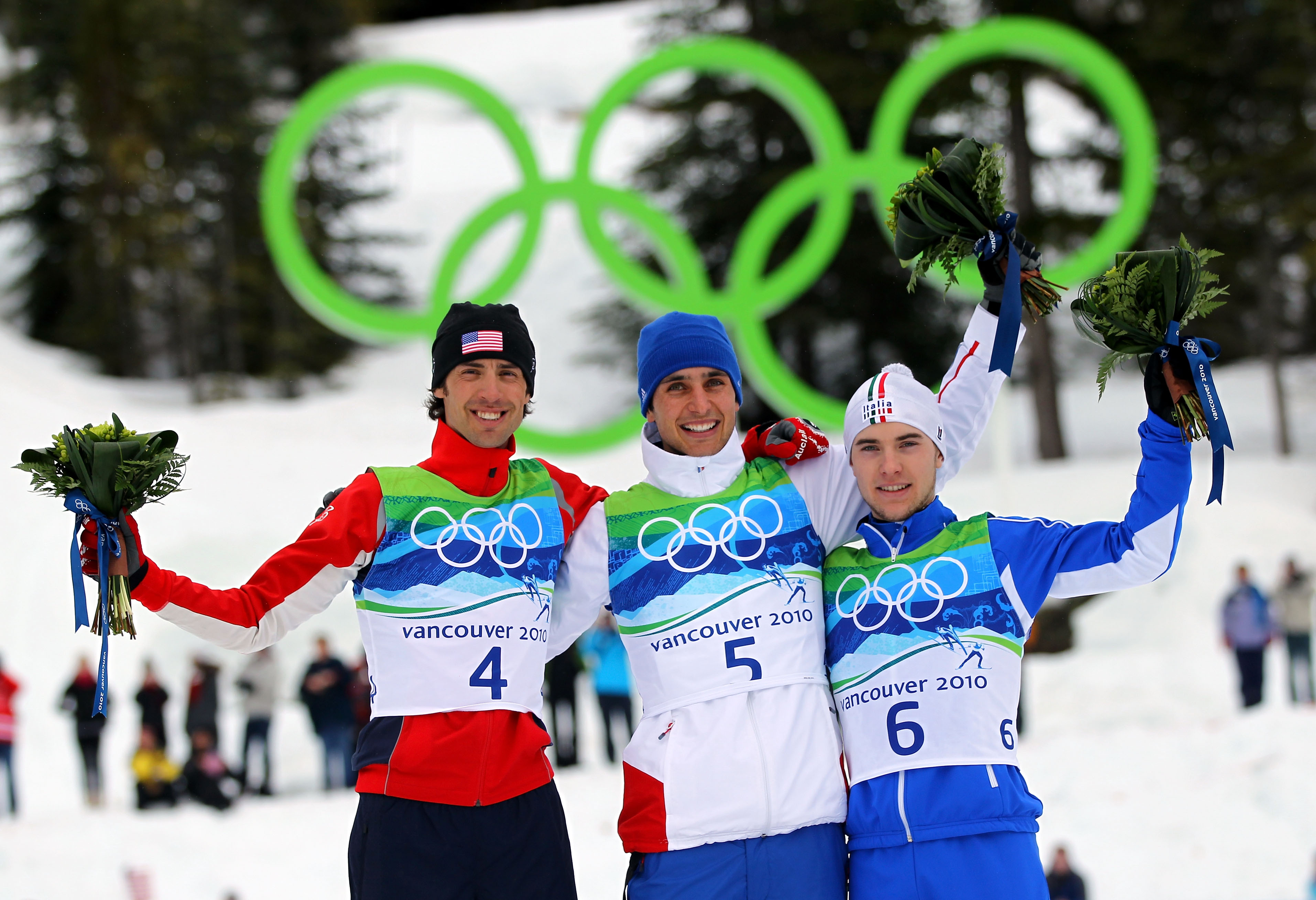 WHISTLER, BC - FEBRUARY 14: (L-R) Johnny Spillane (silver) of United States, Jason Lamy Chappuis (gold) of France and Alessandro Pittin (bronze) of Italy pose during the flower ceremony following the Nordic Combined Men's Individual 10km on day 3 of the 2010 Winter Olympics at Whistler Olympic Park Cross-Country Stadium on February 14, 2010 in Whistler, Canada. (Photo by Lars Baron/Getty Images)