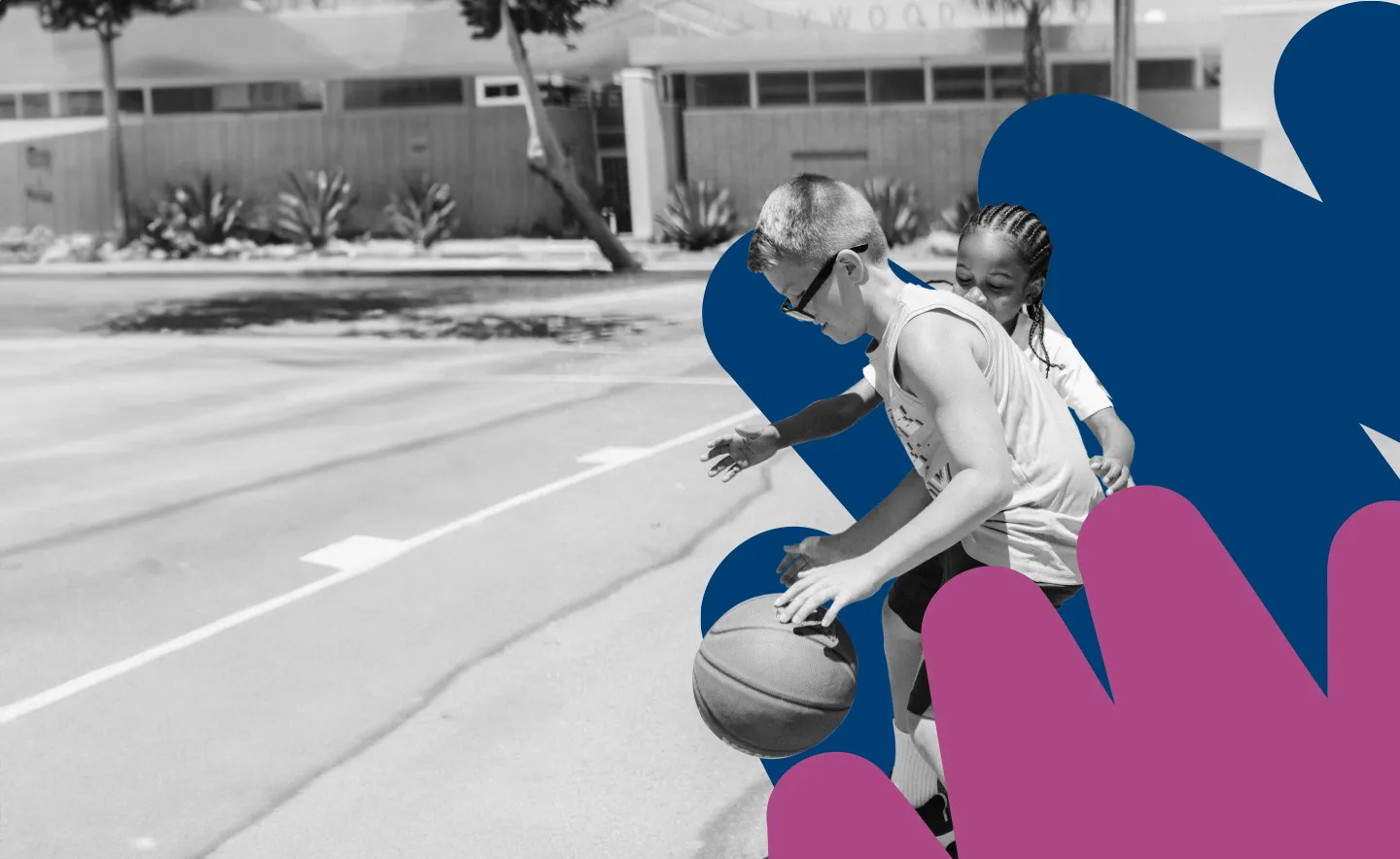 a boy and a girl are playing basketball on a court